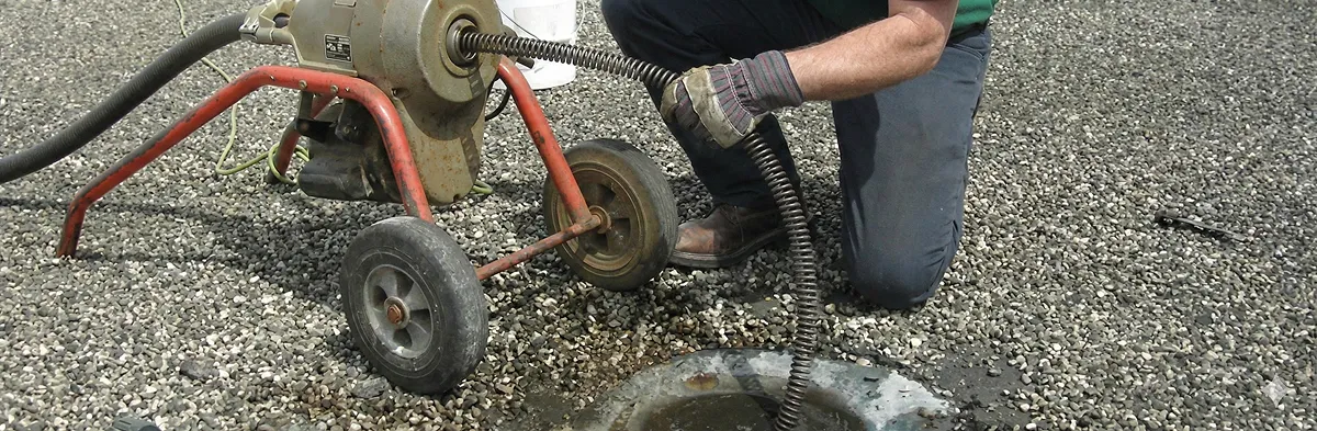 sewer rodding technician actively removing blockages from a sewer line in Columbia, MO