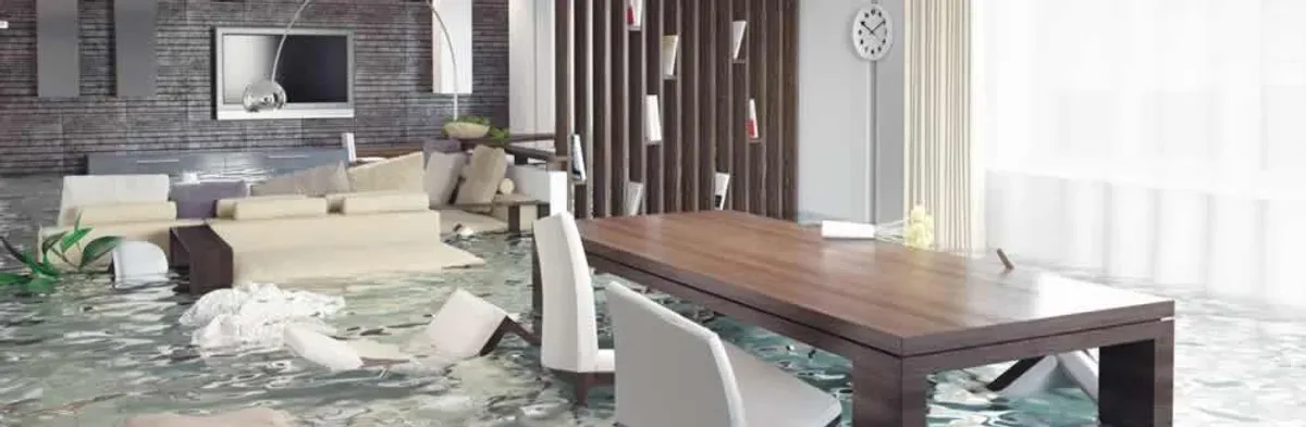 home interior affected by water damage with flooded floors and displaced furniture in Columbia, MO